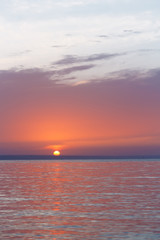 early sunrise morning landscape / the sun rising over the water