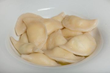 Spinach Dumplings in a white plate on a black background
