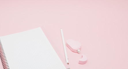 Notebook, white sheet, pencil, proofreader. Pink background.Instagram concept