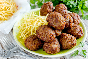 Turkish meatballs kuru kofte garnished with fried potato straws