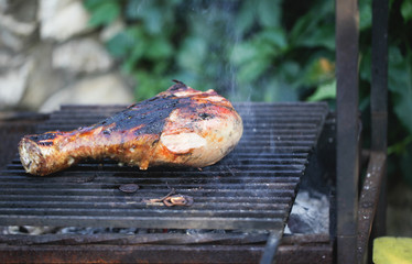 Snack For Outdoor Summer Barbeque Party.Family dinner in the open air. Barbeque grilled turkey legs. cooking on open fire