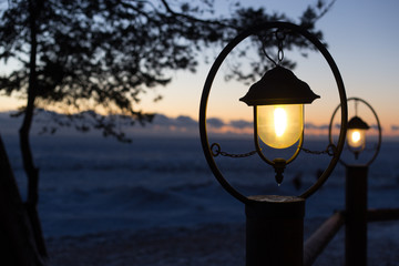 old style lighted street lantern at the restaraunt in the street