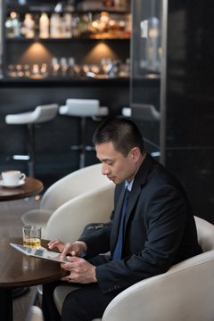 Businessman using digital tablet in hotel