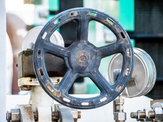 detail of a manual valve with black steering wheel