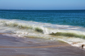 View of White Wave Receding on Perfect Sandy Beach.