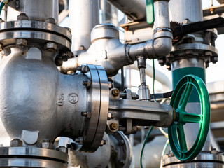 detail of a manual valve with green steering wheel