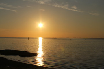 beautiful sunset over the water in the evening in summer