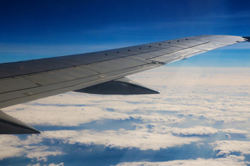 Fototapeta premium Seeing the plane's wing and the outer view from the window.