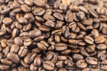 Brown roasted coffee beans. Espresso dark, aroma, black caffeine drink. The foreground in focus, back is not focus.