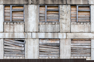 old multi-storey gray boarded up wooden worn-out building