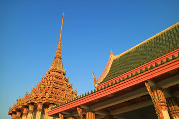 Fototapeta premium Stunning Decorated Roofs of Wat Khao Di Salak Buddhist Temple against Vivid Blue Sky, Suphanburi Province, Thailand 
