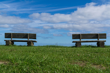 2 benches in a meadow with clear view to the horizon