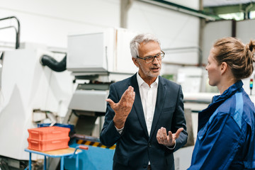 Manager and skilled worker of a high tech enterprise having a meeting