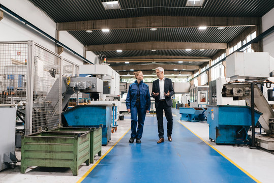 Manager and skilled worker of a high tech enterprise having a meeting
