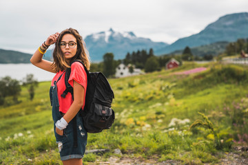 Young woman with a backpack traveling Norwegian Lapland