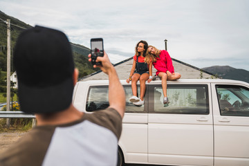 Friends traveling through Norwegian Lapland with a camping van
