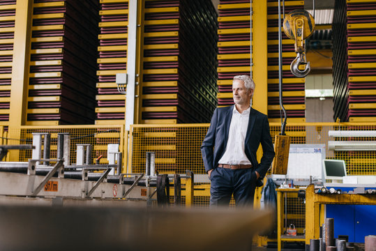 Successful entrepreneur standing in his company