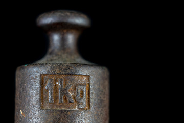 A kilogram weight used for weighing a given quantity in the store. Weights of one kilogram and two kilograms.