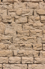 The old wall of a house built of clay bricks.