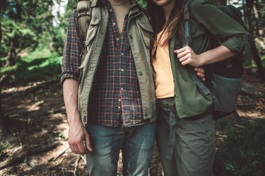 Concept of life activity in couple. Close up portrait of man and woman in special tourist clothes standing together uphill in forest