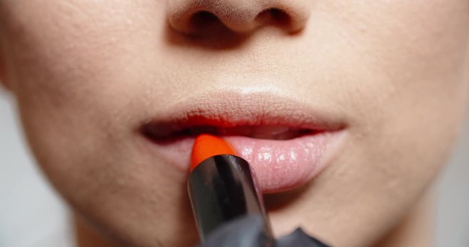 Woman Applying Lipstick. Young Model Putting On Some Makeup, Using Lipstick To Color Hel Lips - Beauty Concept Closeup 4k