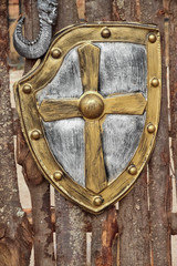 medieval shield foreground over tree trunks