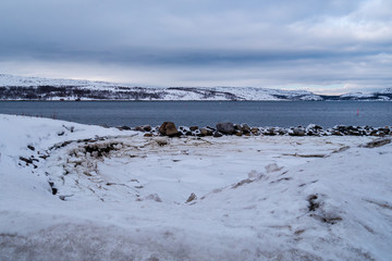 Norway landscape view with ice and snow during winter with a stunning colored sky