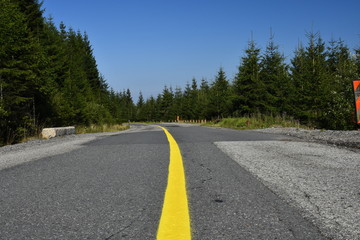Yellow painted line on the middle of the road.