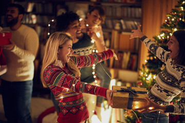 Fototapeta na wymiar giving Christmas gifts happy females