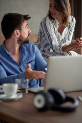 Man and woman with laptop spending time together at home.