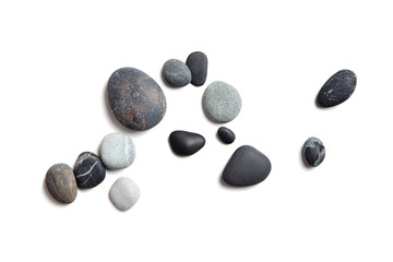 Scattered sea pebbles. Smooth gray and black stones isolated on white background. Top view