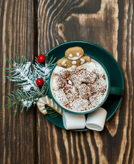 Obraz na płótnie Canvas cup of hot cocoa with marshmallow, cookies, fir-tree on wooden background