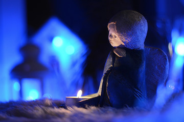 Still life with a candlestick the figure of the angel in the Christmas lights
