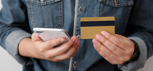 Man hand holding credit card and smart phone for  shopping online concept, business, finance and technology, online payment, digital money concept