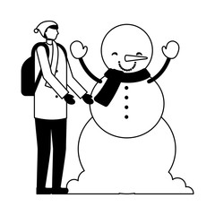 man with winter clothes and snowman