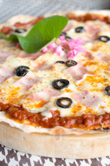 Italian pizza with ham olives and mushrooms