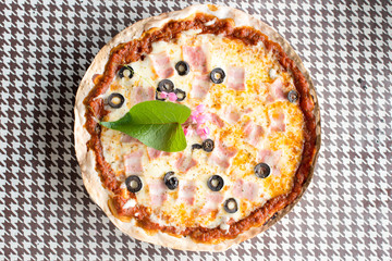 Italian pizza with ham olives and mushrooms