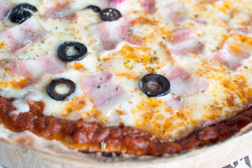 Italian pizza with ham olives and mushrooms