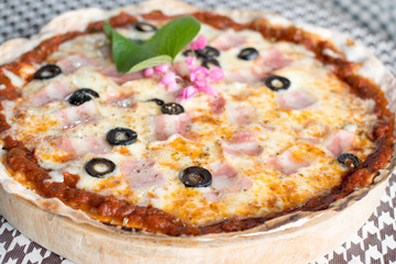 Italian pizza with ham olives and mushrooms