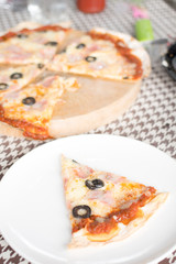 Italian pizza with ham olives and mushrooms