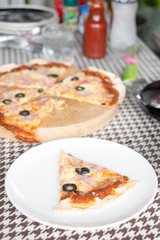 Italian pizza with ham olives and mushrooms