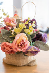 Colorful plastic rose flowers in sacks