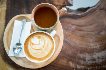 Hot latte art coffee on wood table