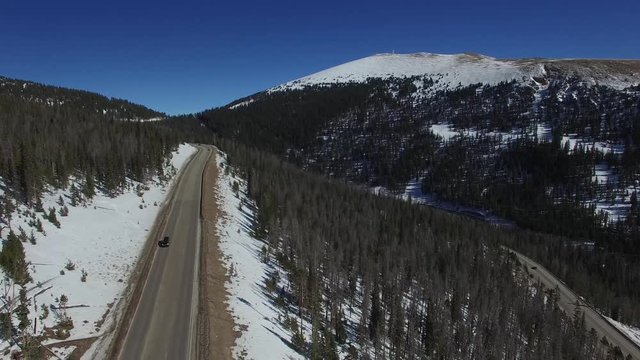 Aerial drone footage of Colorado highway over Berthoud Pass and Continental Divide (up and down)