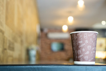 Paper cup of coffee  on bright background