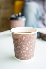 Paper cup of coffee  on bright background