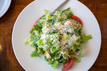 Top view of Fresh healthy  Caesar salad on white plate