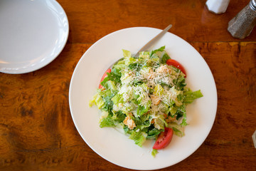 Top view of Fresh healthy  Caesar salad on white plate
