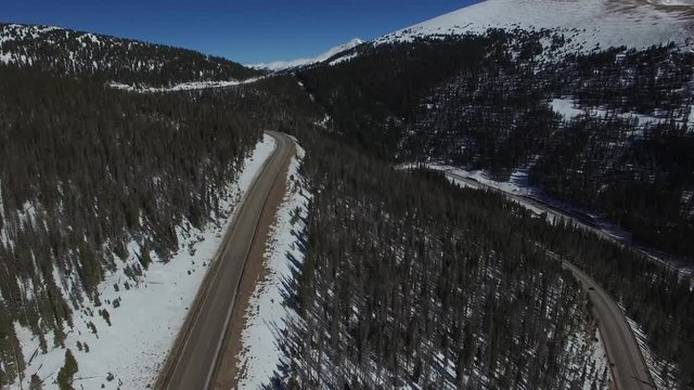 Aerial drone footage of Colorado highway over  Berthoud Pass and Continental Divide (forward)