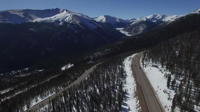 Aerial drone footage of Colorado highway over Berthoud Pass and Continental Divide (forward)
